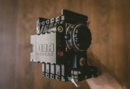 person holding black Red Dragon land camera
