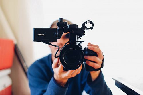 person holding DSLR camera