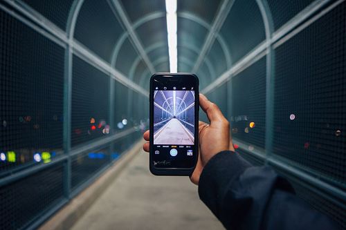 person holding phone showing empty tunnel