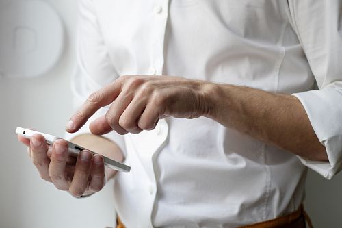 person holding white Android smartphone in white shirt