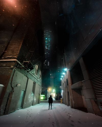person standing between concrete buildings
