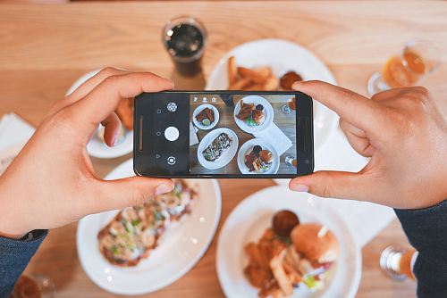 person taking picture of the foods