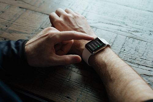 person touching Apple watch