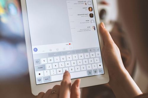 person using white iPad