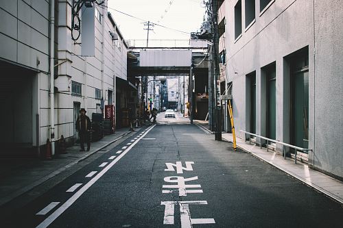 person walking near road during daytime