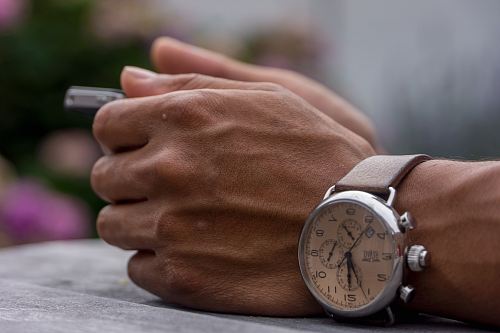 person wearing chronograph watch