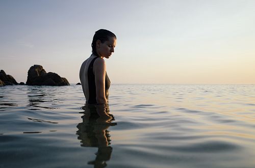 photo of woman on sea during daytime