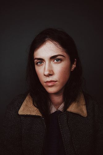 portrait photograph of woman in gray and brown coat