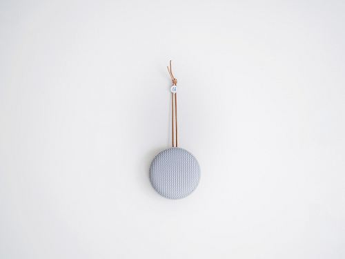 round grey hanging decor on white wall