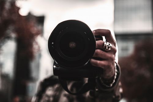 selective focus photo of person holding camera