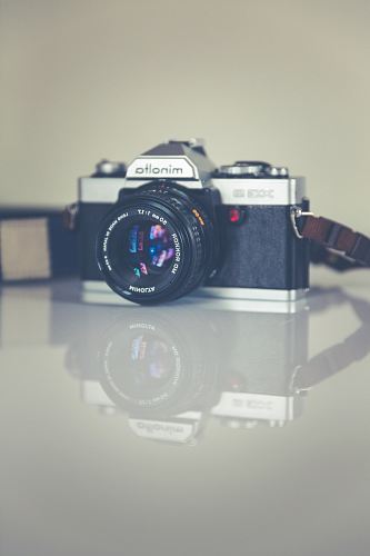 selective focus photography of gray and black Minolta camera