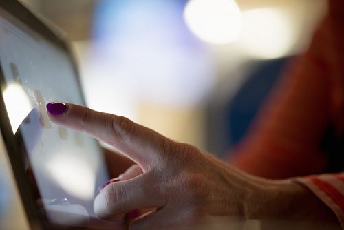 selective focus photography of person pointing at tablet computer