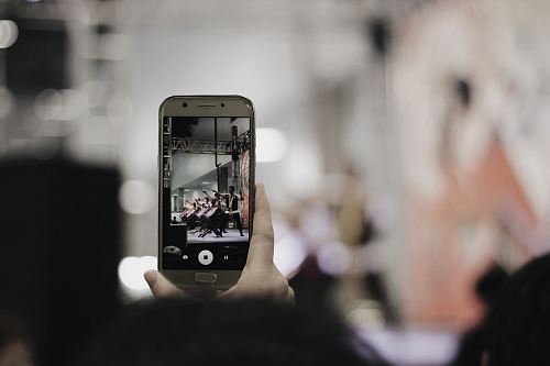 selective focus photography of person using silver smartphone
