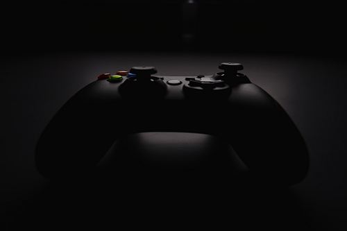 shallow focus photography of black Xbox controller