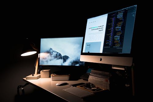 silver iMac turned on inside room