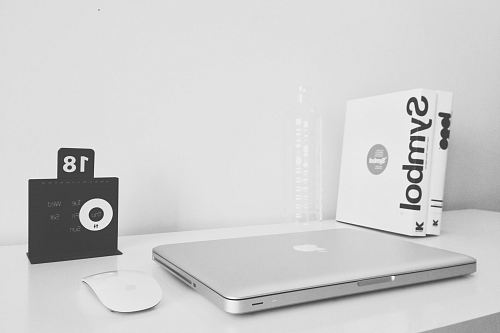 silver MacBook and black JBL
