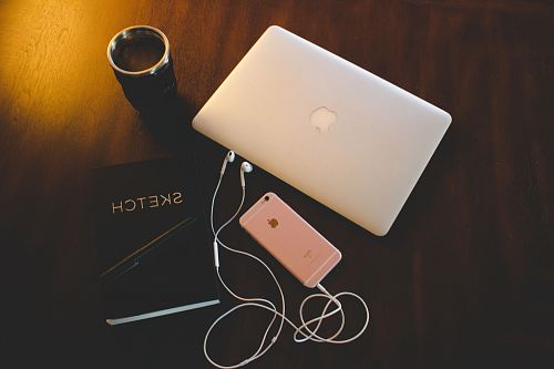 silver MacBook and rose gold iPhone 6s