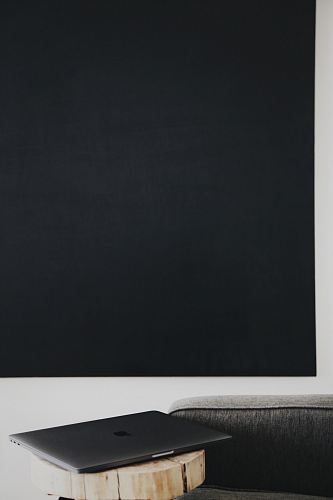 silver MacBook on brown wooden plank