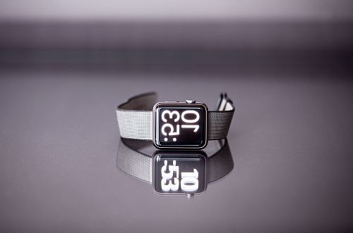silver titanium Apple Watch with gray nylon strap