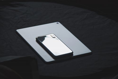 space gray iPhone X on tablet computer