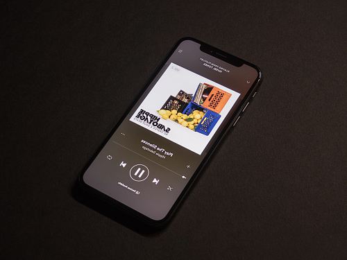 space gray iPhone X showing Spotify application