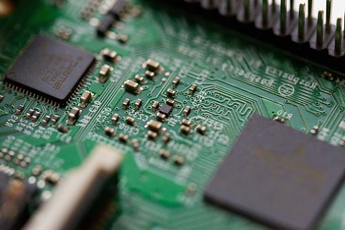 tilt-shift photography of green computer motherboard