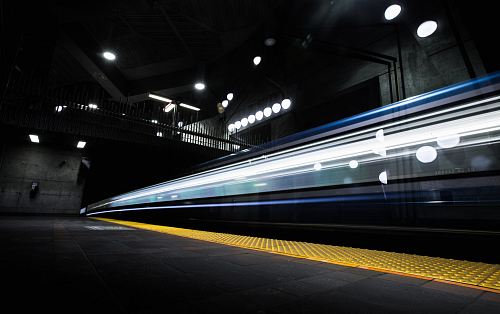 timelapse photography of train passing on track
