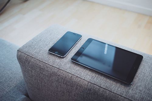 turned off iPad And iPhone 6 on sofa arm