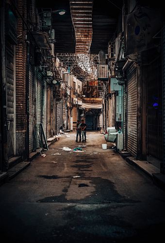 two men walking on street photo