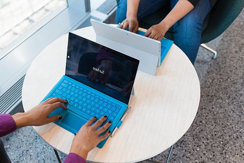 two person using Microsoft Surface