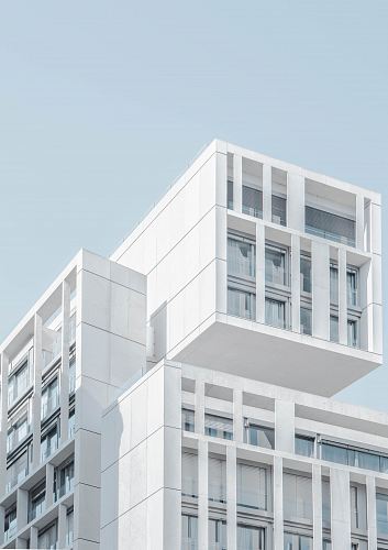 white modern cement building under blue sky