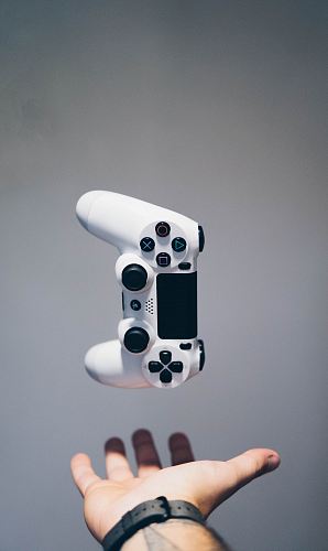 white Sony PS4 DualShock controller over person's palm