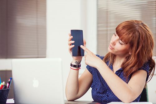 woman holding an Android smartphone