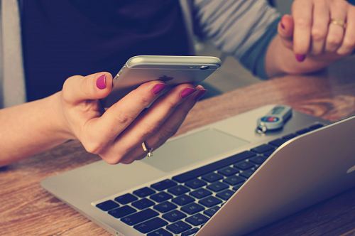 woman holding silver iPhone 6