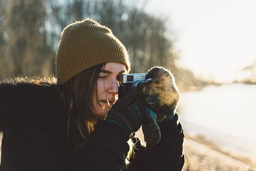 woman holding SLR camera
