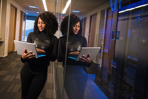 woman in black shirt using laptop computer
