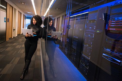 woman in black top using MacBook