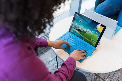 woman in purple sweater using laptop