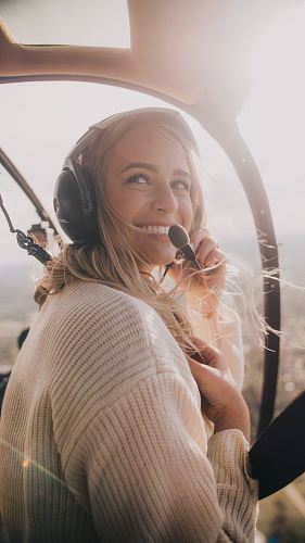 woman in white knit sweater inside aircraft