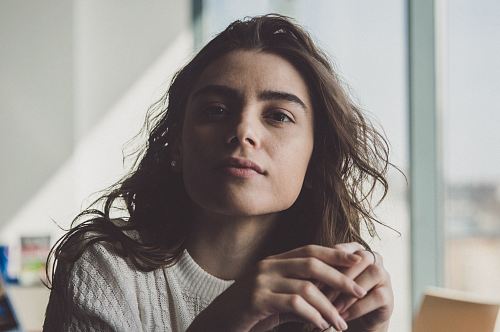 woman sitting near glass window