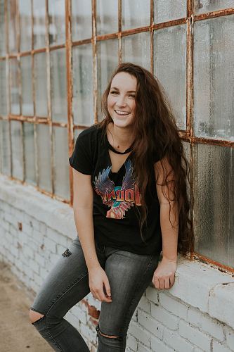 woman sitting on windowsill laughing