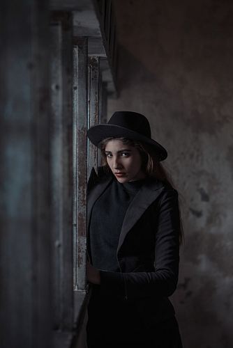 woman standing beside steel fence