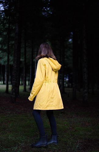 woman standing near green leafed trees