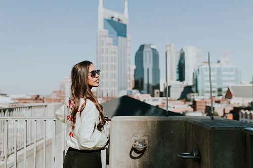 woman standing near hand rails during daytime