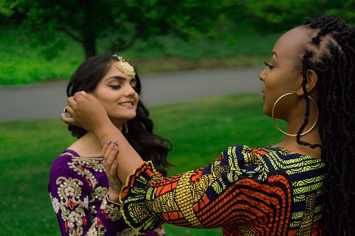 woman steering on girl holding his ears