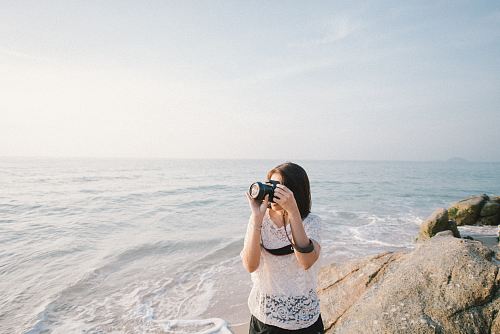 woman taking a photo using a DSLR camera
