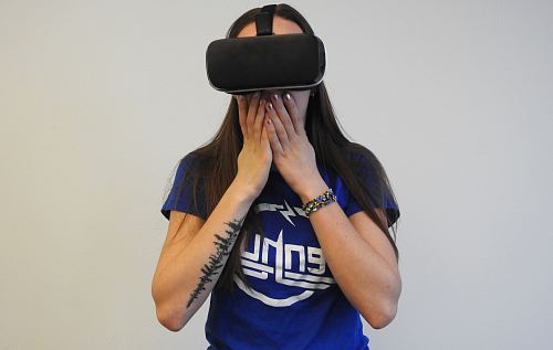 woman using black VR headset