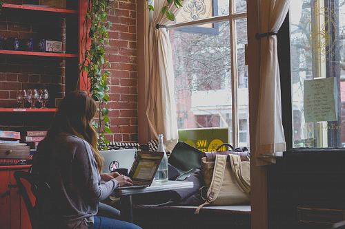 woman using computer sitting on black chair