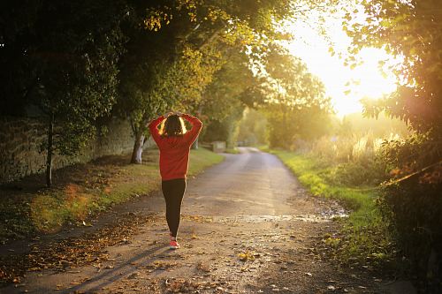 woman walking on pathway during daytime