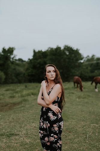 woman wearing black and pink floral spaghetti-strap rompers